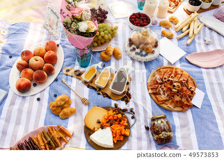Summer picnic blue blanket with tasty food and Summer picnic blue blanket with tasty food and 49573853