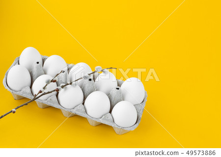 White chicken eggs in an open cardboard box on a White chicken eggs in an open cardboard box on a 49573886