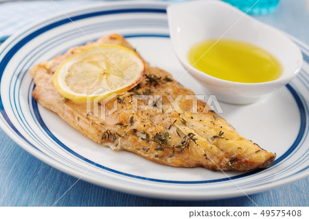 Fried fish with lemon and spices Fried fish with lemon and spices 49575408