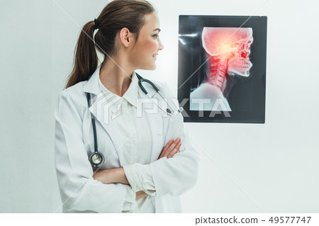 Doctor working with x ray film of patient head. 49577747