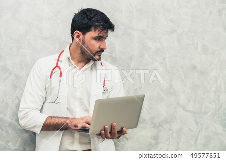 Doctor using laptop computer at the hospital. 49577851