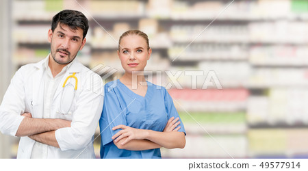 Doctors at hospital working with another doctor. 49577914