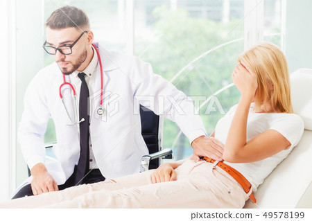 Male Doctor and Female Patient in Hospital Office Male Doctor and Female Patient in Hospital Office 49578199