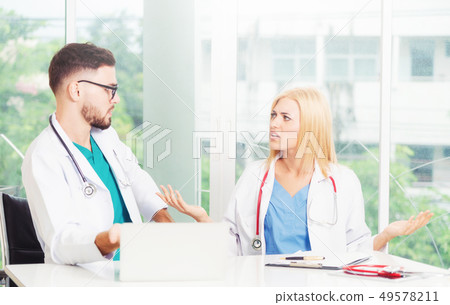 Two doctors partner works at office in hospital. Two doctors partner works at office in hospital. 49578211