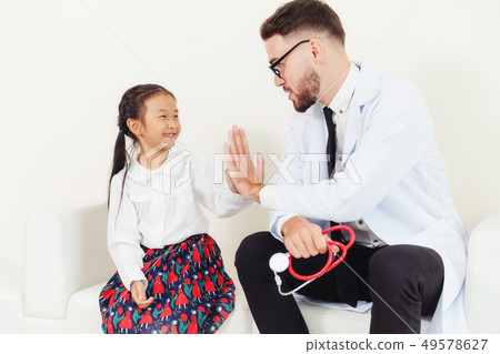Happy little kid visit doctor in hospital office. 49578627
