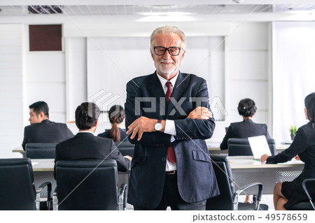 Senior executive CEO manager with team members. Senior executive CEO manager with team members. 49578659