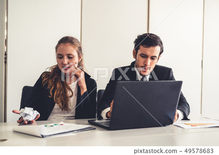 Unhappy serious businessman and businesswoman. 49578683