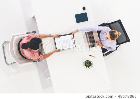 Two young business women meeting for interview. 49578865