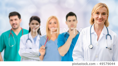 Doctor working in hospital with other doctors. Doctor working in hospital with other doctors. 49579044