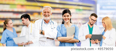 Doctor working in hospital with other doctors. Doctor working in hospital with other doctors. 49579050