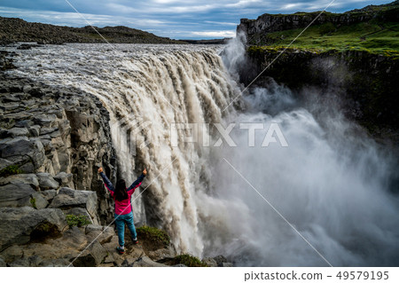 Traveler Travels to Dettifoss Waterfall in Iceland Traveler Travels to Dettifoss Waterfall in Iceland 49579195