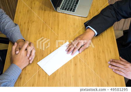 Hand of a businessman hands over a resignation Hand of a businessman hands over a resignation 49581295