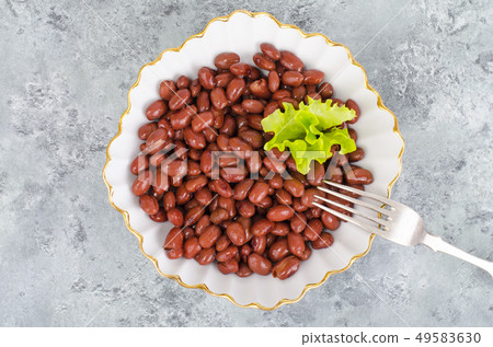 Red canned beans in white plate on gray background Red canned beans in white plate on gray background 49583630