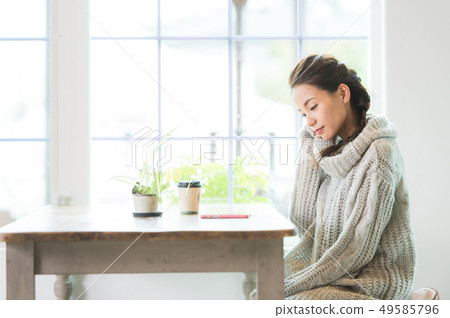 A woman relaxing at the window 49585796