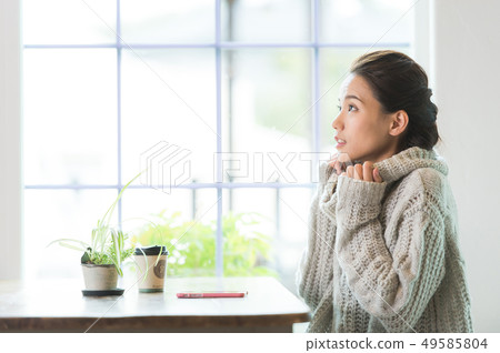 A woman relaxing at the window A woman relaxing at the window 49585804