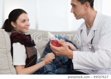 Doctor Visiting Sick Young Woman in Scarf at Home. Doctor Visiting Sick Young Woman in Scarf at Home. 49587627