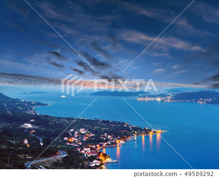Night summer coastline and village on seashore Night summer coastline and village on seashore 49589292