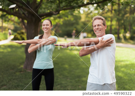 Man and Woman Warm Up Outdoor. Sport in Park. 49590322