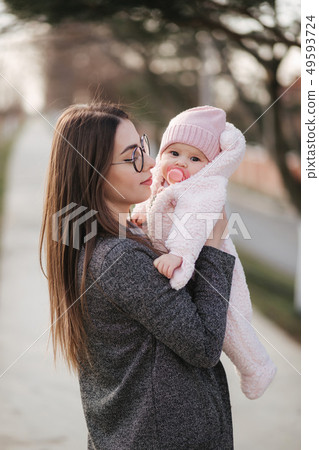 Portrait of mother and her little baby girl. Beautiful mom and cute baby. Mother hud her daughter Portrait of mother and her little baby girl. Beautiful mom and cute baby. Mother hud her daughter 49593724