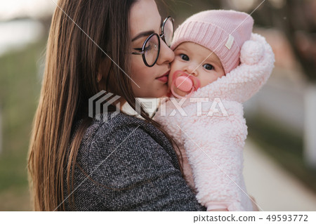 Portrait of mother and her little baby girl. Beautiful mom and cute baby. Mother hud her daughter Portrait of mother and her little baby girl. Beautiful mom and cute baby. Mother hud her daughter 49593772