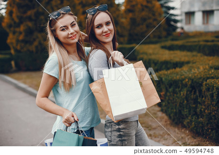 Cute girls with shopping bag in a city Cute girls with shopping bag in a city 49594748