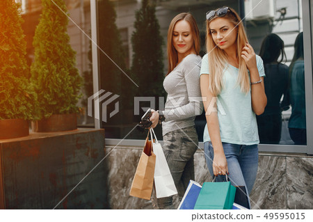 Cute girls with shopping bag in a city Cute girls with shopping bag in a city 49595015