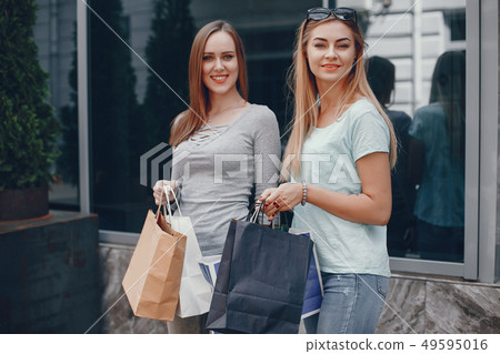 Cute girls with shopping bag in a city Cute girls with shopping bag in a city 49595016