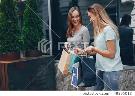 Cute girls with shopping bag in a city 49595018