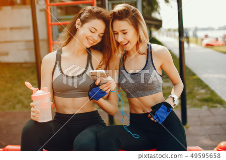 Two beautiful girls are engaged in sports Two beautiful girls are engaged in sports 49595658