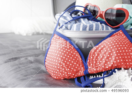 Bikini and summer accessories in luggage on the Bikini and summer accessories in luggage on the 49596093