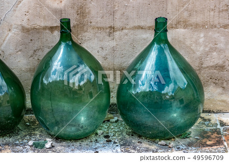 Large green glass wine jars in Matera, Italy Large green glass wine jars in Matera, Italy 49596709