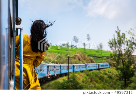 Woman enjoying train ride through Sri Lanka tea Woman enjoying train ride through Sri Lanka tea 49597315