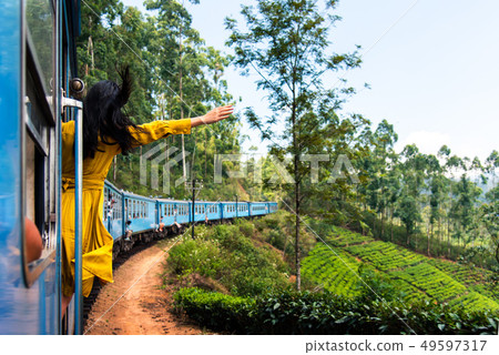 Woman enjoying train ride through Sri Lanka Woman enjoying train ride through Sri Lanka 49597317