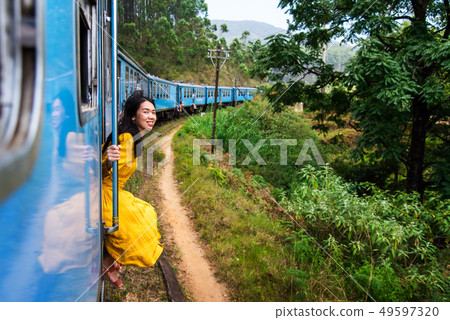 Woman sitting by the train door Sri Lanka Woman sitting by the train door Sri Lanka 49597320
