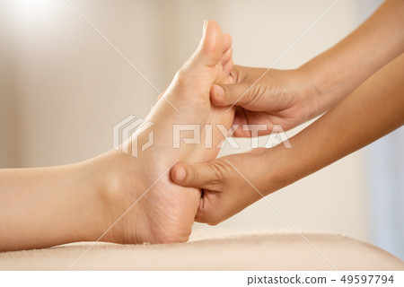 Foot Massage at the spa salon. Foot Massage at the spa salon. 49597794