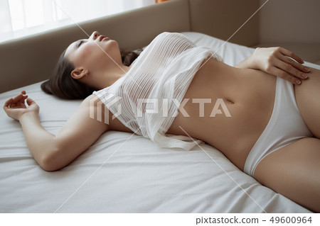 Attractive sensual woman in lingerie on bed in Attractive sensual woman in lingerie on bed in 49600964