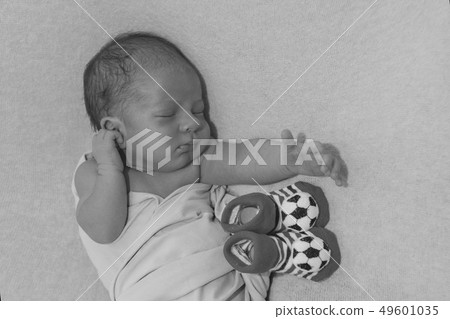 Newborn baby and baby booties with soccer ball 49601035