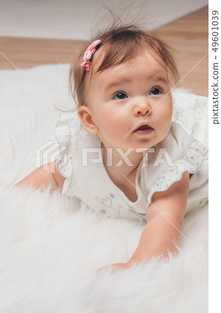 little girl with a tail on her head crawling on 49601039