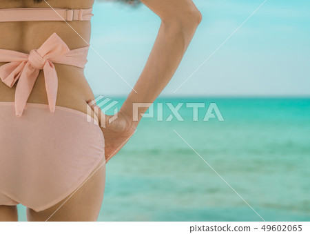Back view of sexy adult Asian woman on the beach. Back view of sexy adult Asian woman on the beach. 49602065