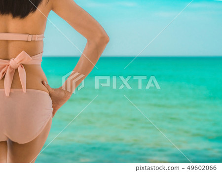 Back view of sexy adult Asian woman on the beach. Back view of sexy adult Asian woman on the beach. 49602066