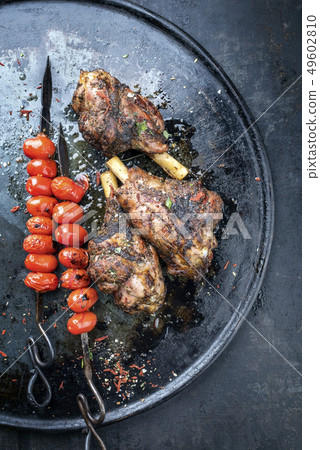 Barbecue leg of lamb and a tomato skewer  49602810