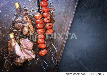 Barbecue leg of lamb and a tomato skewer Barbecue leg of lamb and a tomato skewer 49602817