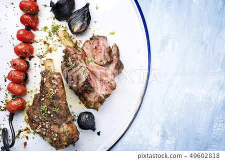 Barbecue leg of lamb and a tomato skewer  49602818
