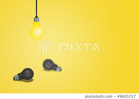 Yellow light bulb hanging from ceiling. Yellow light bulb hanging from ceiling. 49603257