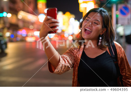 Young happy Asian tourist woman taking selfie at Chinatown in Bangkok 49604395