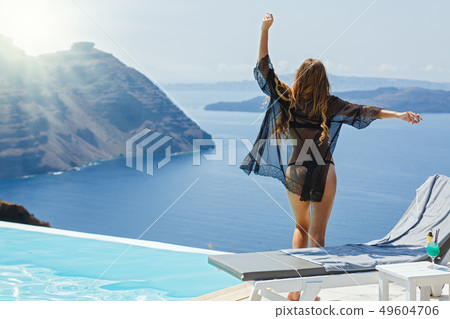 Young woman by the pool 49604706