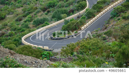 Steep u-shape curved mountain road in the middle of the bush Steep u-shape curved mountain road in the middle of the bush 49605661