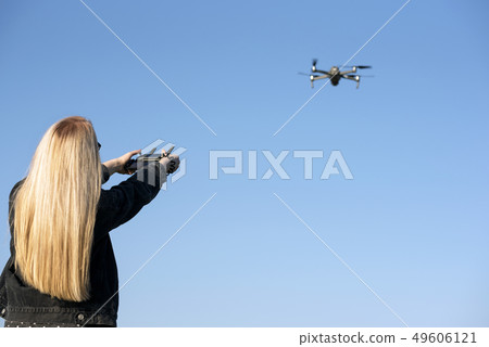 Young girl controls the drone. Drone flight Young girl controls the drone. Drone flight 49606121