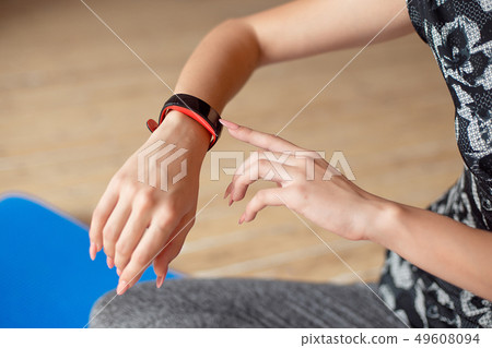 Woman setting up the fitness smart watch for running. Sportswoman checking watch device. 49608094