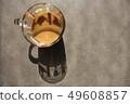 Silhouette from a thicket with coffee on a stone surface 49608857